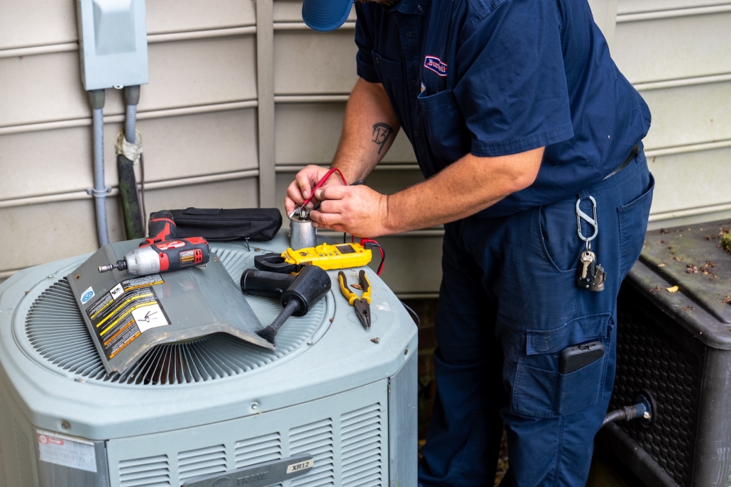 Burch_ActionShots-38 Burch technician working on an outdoor heating/air conditioning unit.