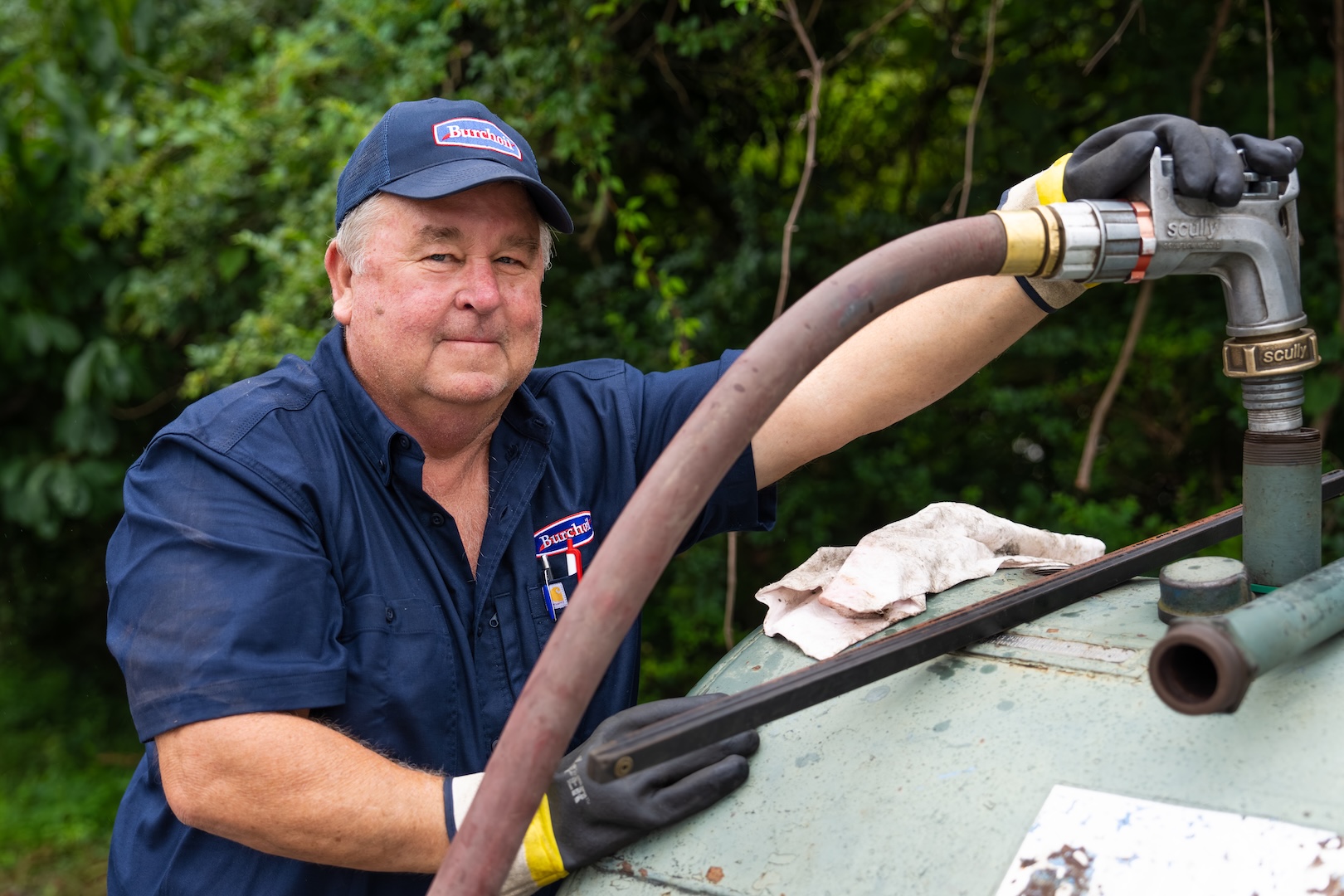 Burch technician filling up a heating oil or fuel tank.