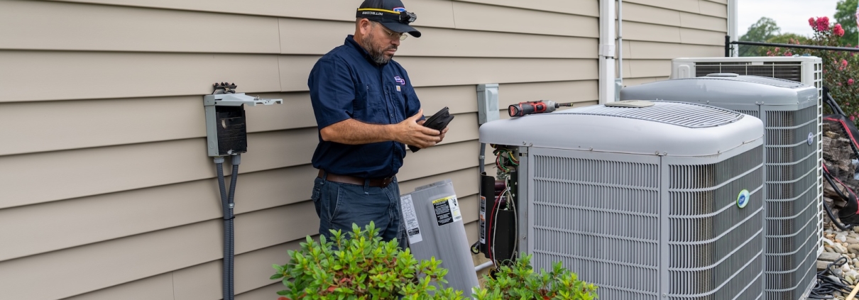 Burch technician working on a heat pump