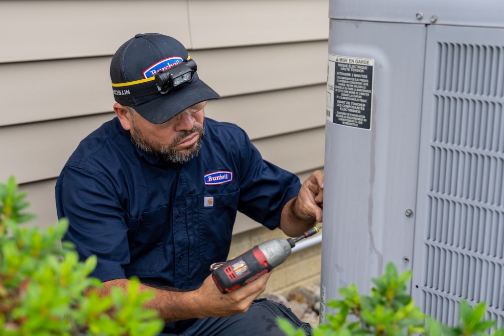 Burch worker maintaining AC unit