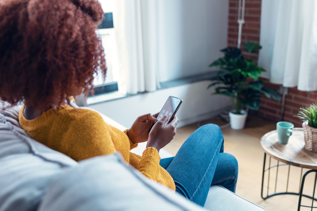 woman on couch with phone