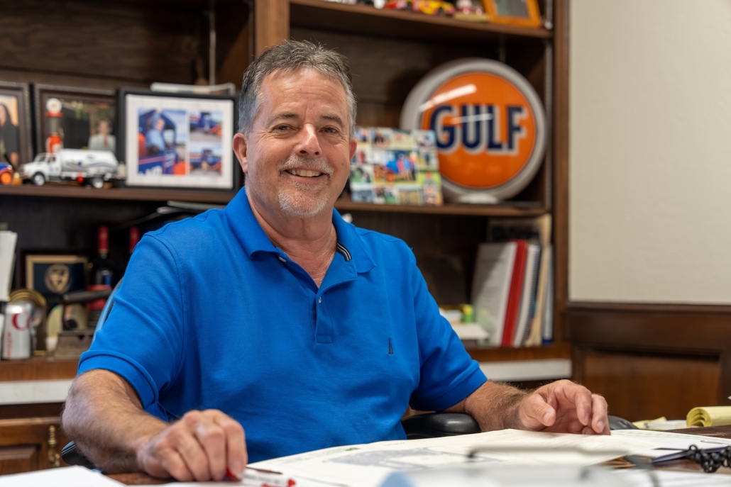 Burch employee at office desk smiling
