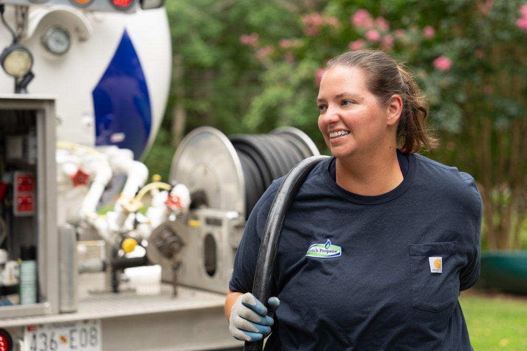 employee pulling fueling hose