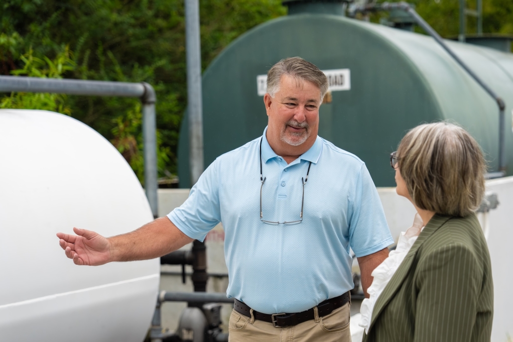 Burch employee explaining tank to customer