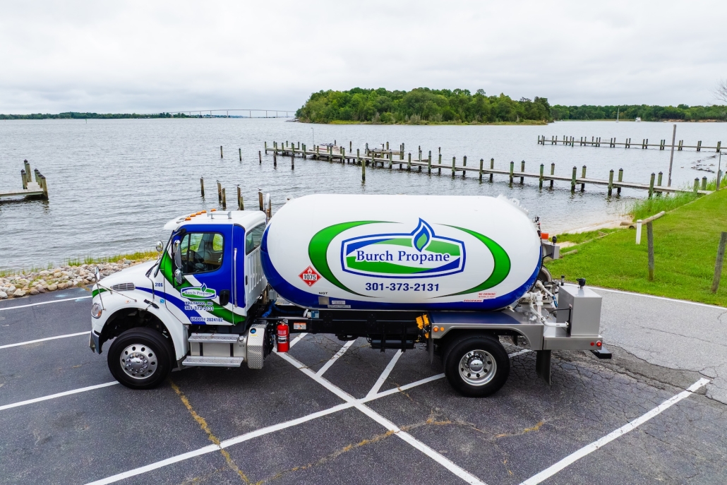 default Burch propane truck in a parking lot next to a lake with docks