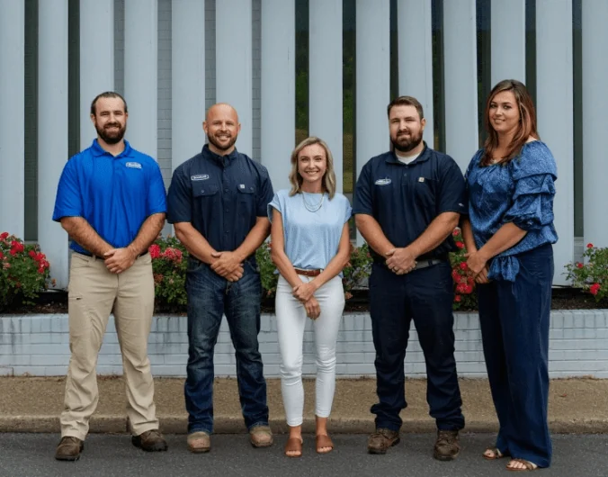 A group of Burch team members standing outside their office.