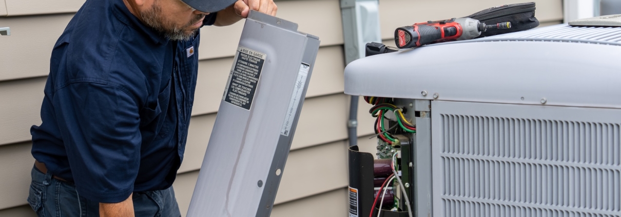 Burch technician working on a heat pump