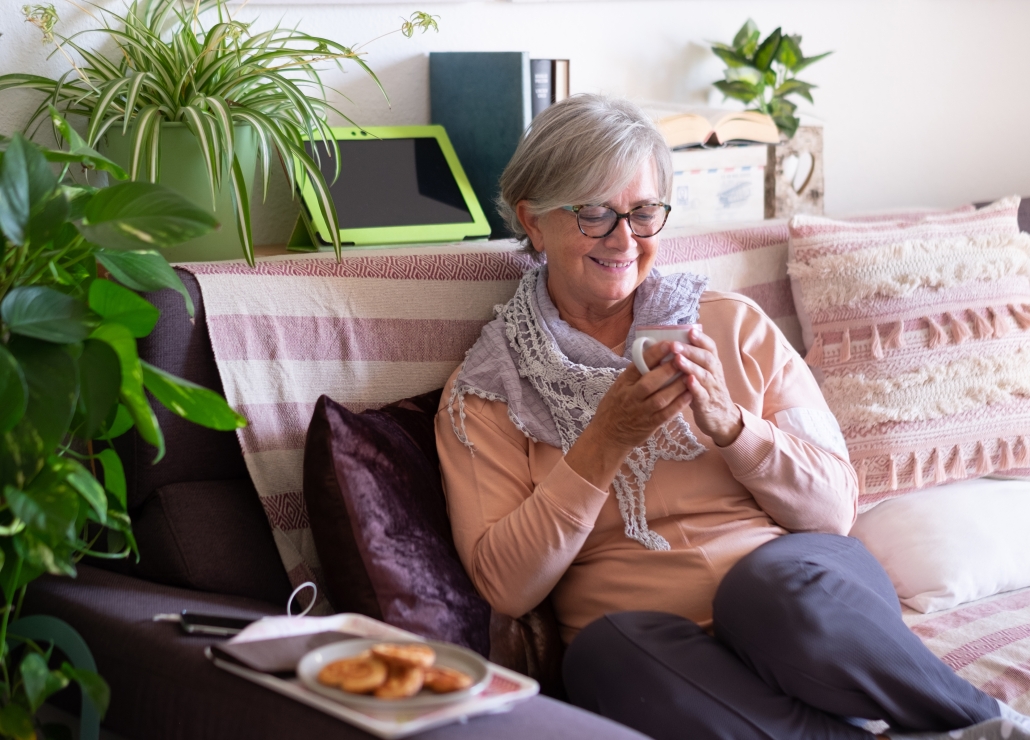 Woman smiling and drinking coffee